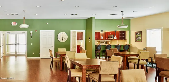 a living room with furniture and a kitchen view
