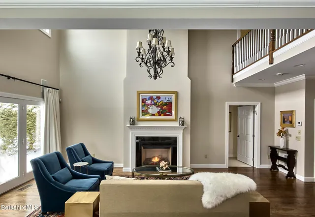 a living room with furniture a fireplace and a large window