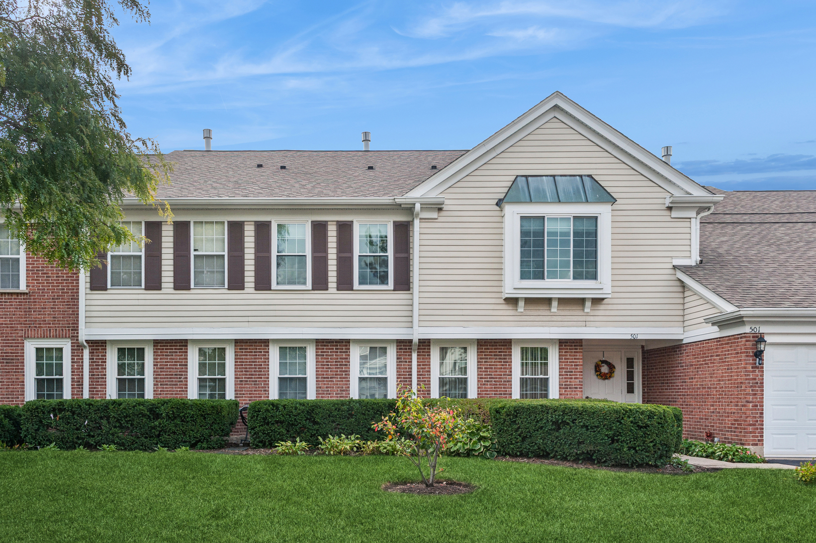 a front view of a house with a yard