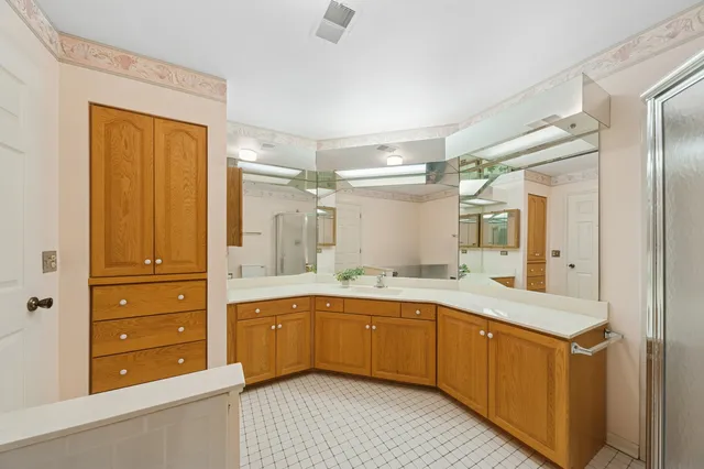 a large bathroom with a double vanity sink mirror and