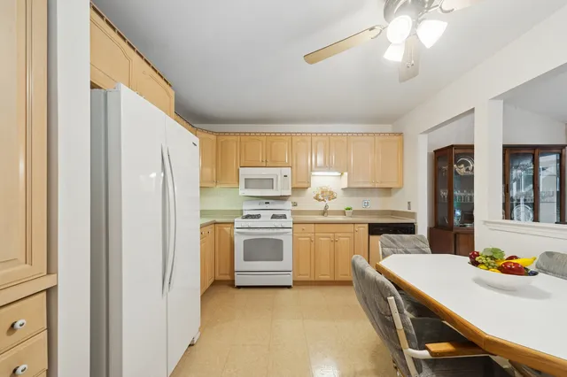 a kitchen with a sink stainless steel appliances and white cabinets