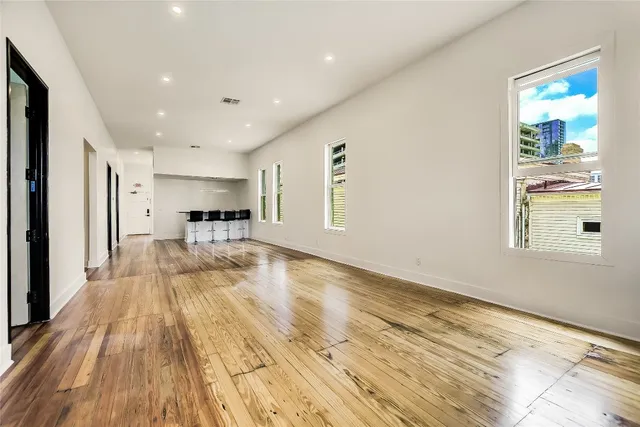 a view of a living room a window and wooden floor