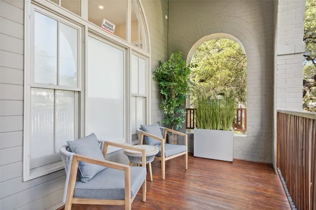 a view of a room with a window and wooden floor