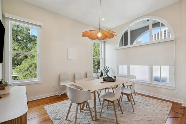 a view of a dining room with furniture window and wooden floor
