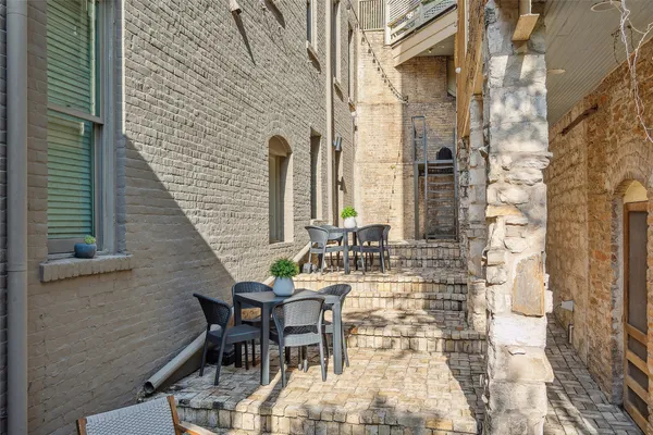 a balcony with table and chairs