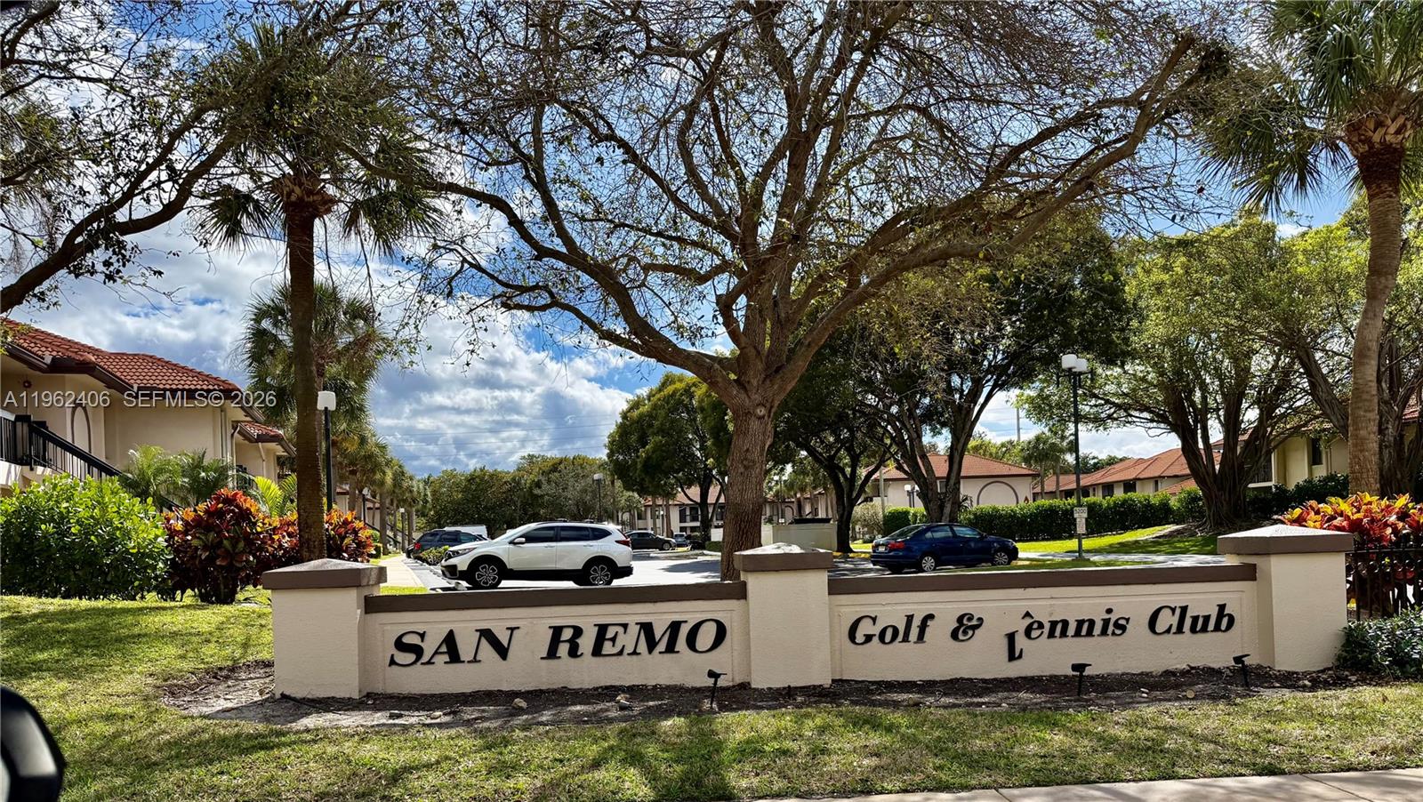 351 Club Circle, Unit 102 Boca Raton, FL 33487 - Photo 1 of 34 a view of sign board with large trees