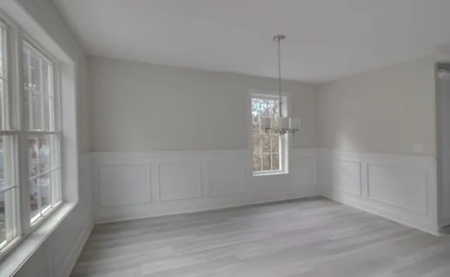 a view of a room window and wooden floor