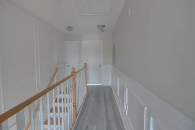 a view of a hallway with wooden floor