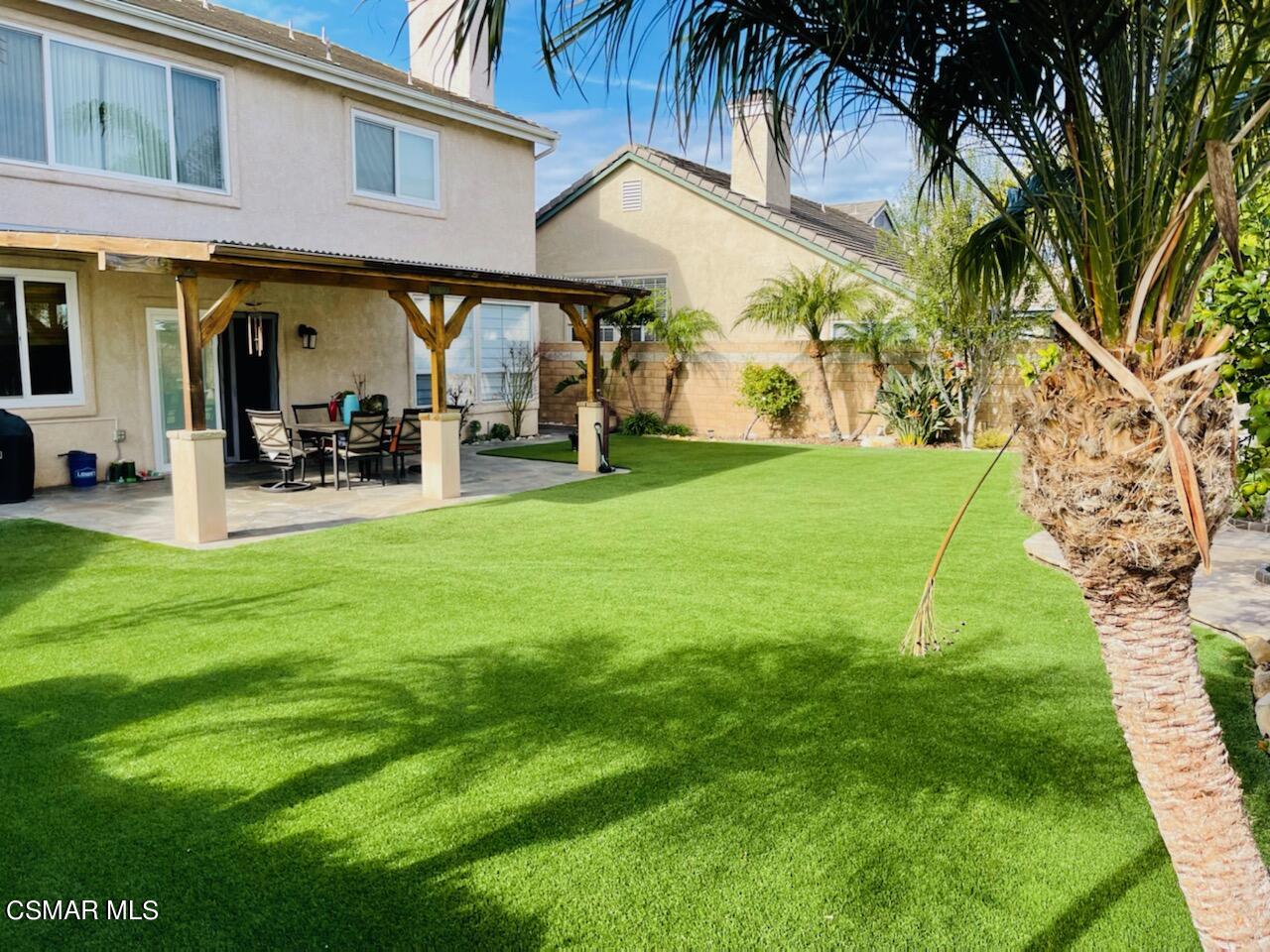 a view of a chairs and table in front of a house