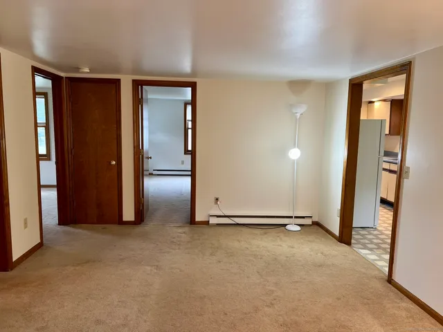 an empty room with closet and mirrors