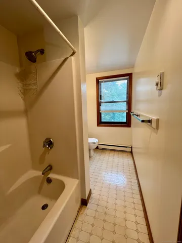 a bathroom with a toilet sink vanity and mirror