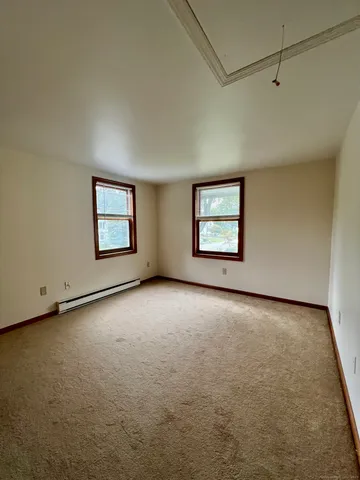 an empty room with windows and closet