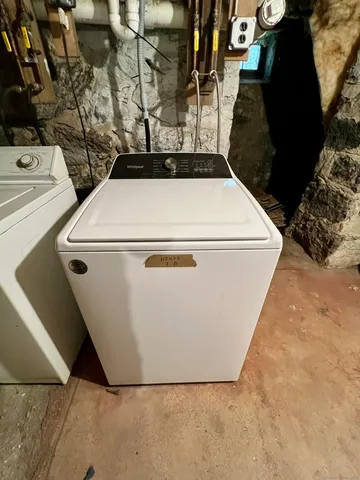 a utility room with a wooden floor