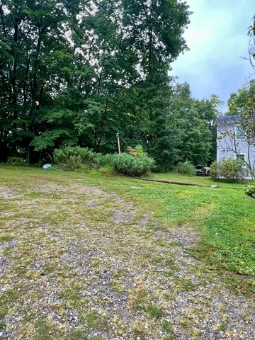 a view of a backyard with sitting area