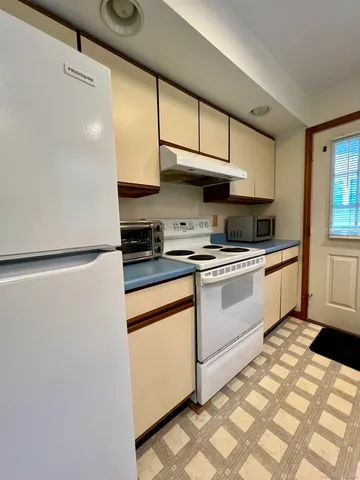 a kitchen with stainless steel appliances granite countertop a sink a stove and a refrigerator