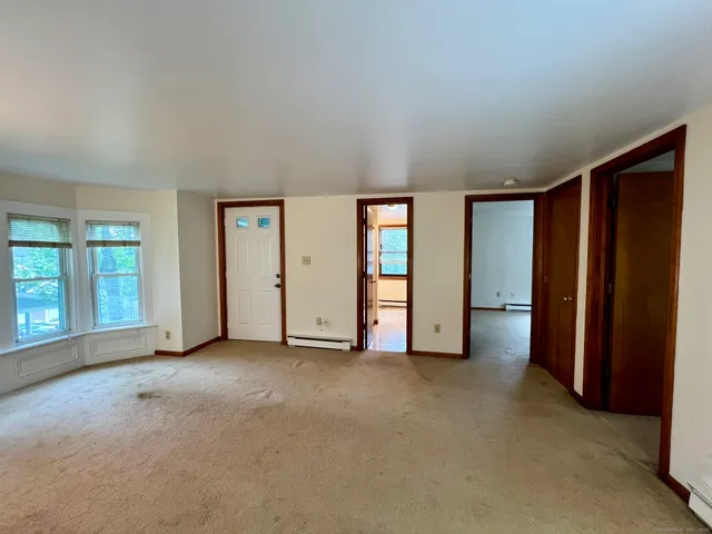 an empty room with closet and a yard
