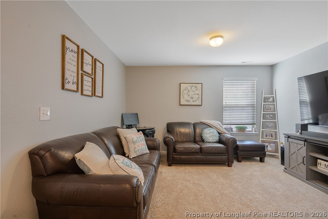 340 Battery Way Bunnlevel, NC 28323 - Photo 21 of 50 a living room with furniture a couch and a flat screen tv