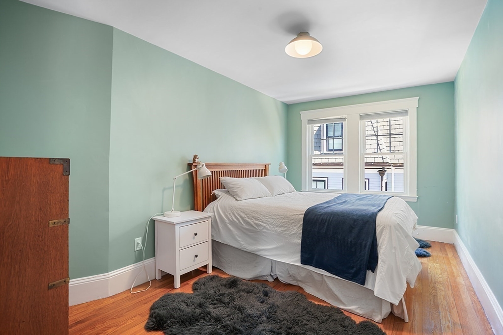 89 Upland Road, Unit 2 Cambridge, MA 02140 - Photo 11 of 17 a bedroom with a bed and wooden floor