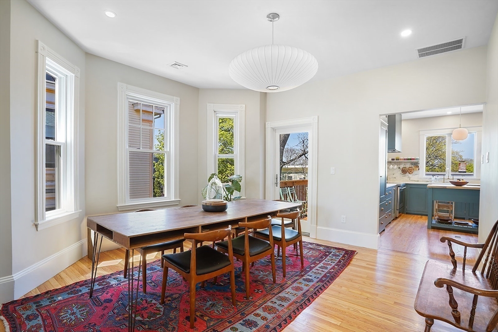 89 Upland Road, Unit 2 Cambridge, MA 02140 - Photo 2 of 17 a view of a dining room with furniture and wooden floor
