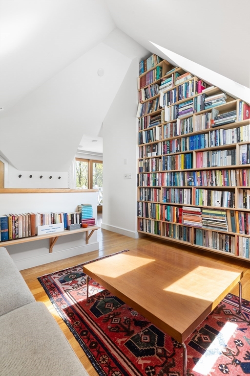 89 Upland Road, Unit 2 Cambridge, MA 02140 - Photo 6 of 17 a living room with furniture a table and bookshelf