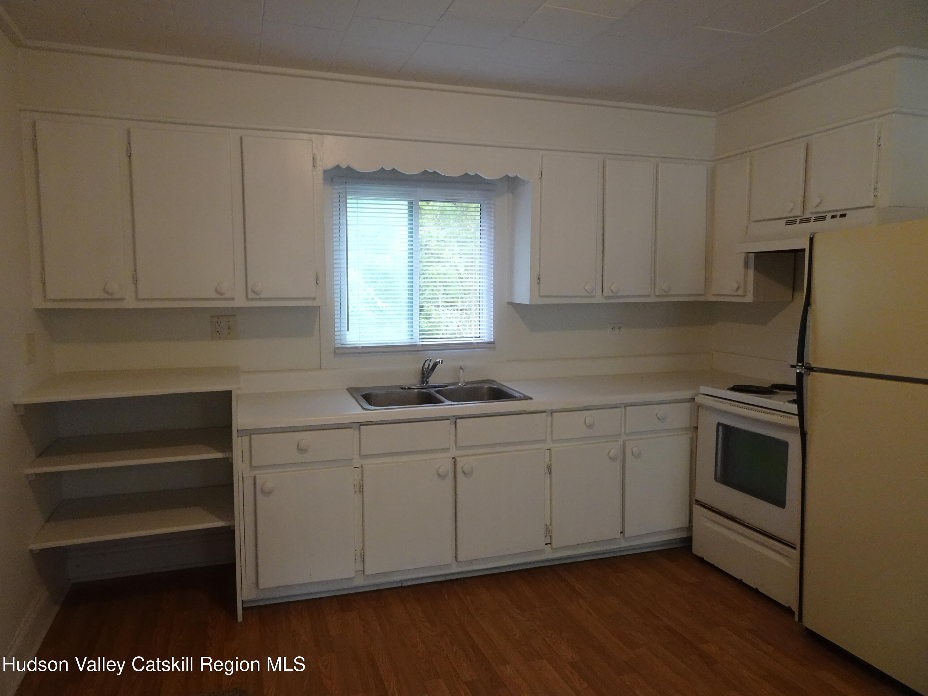 682 Highway 217 Hudson, NY 12534 - Photo 15 of 36 a kitchen with stainless steel appliances white cabinets and a sink