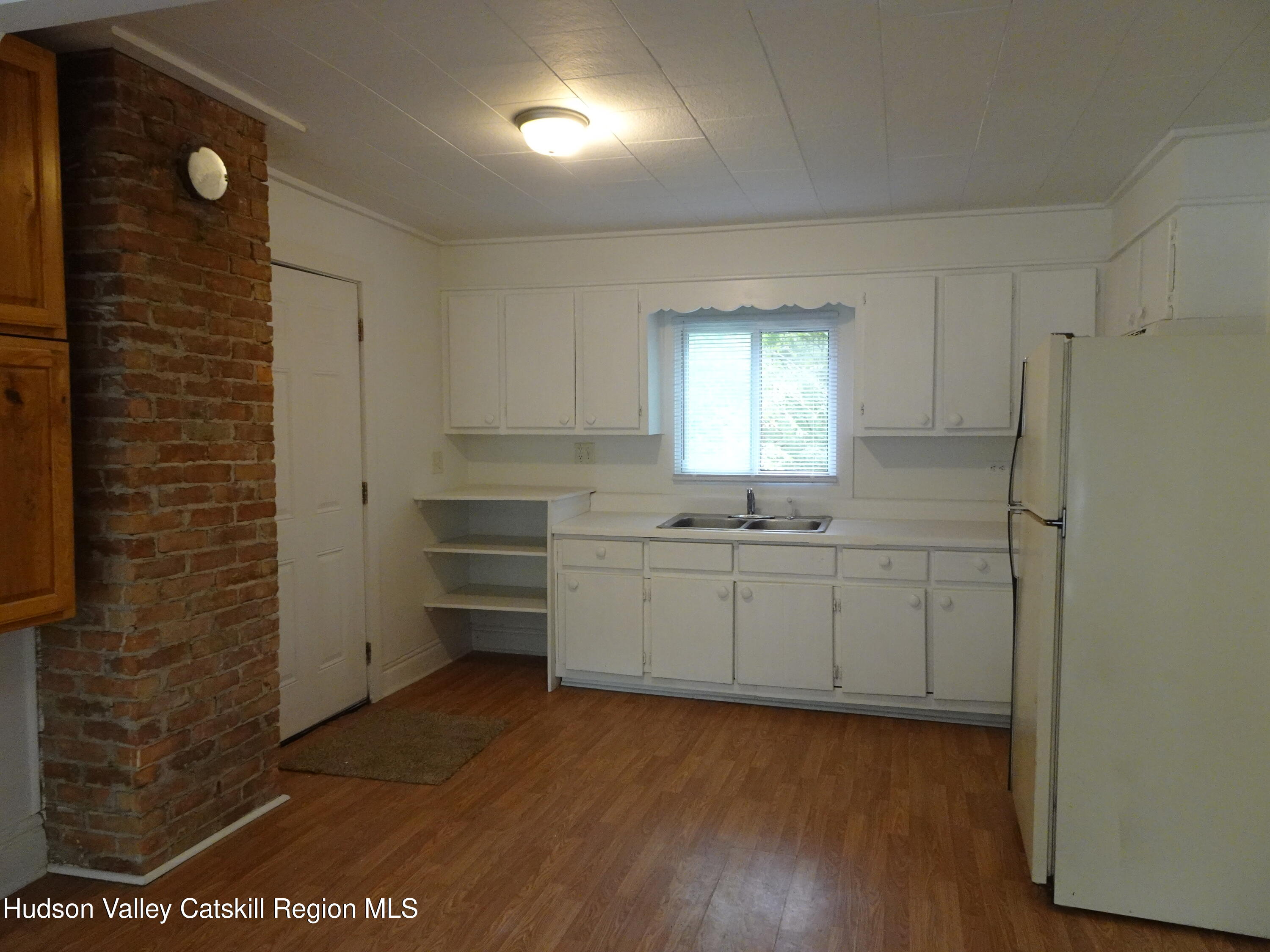682 Highway 217 Hudson, NY 12534 - Photo 16 of 36 a room with a wooden floor and a sink