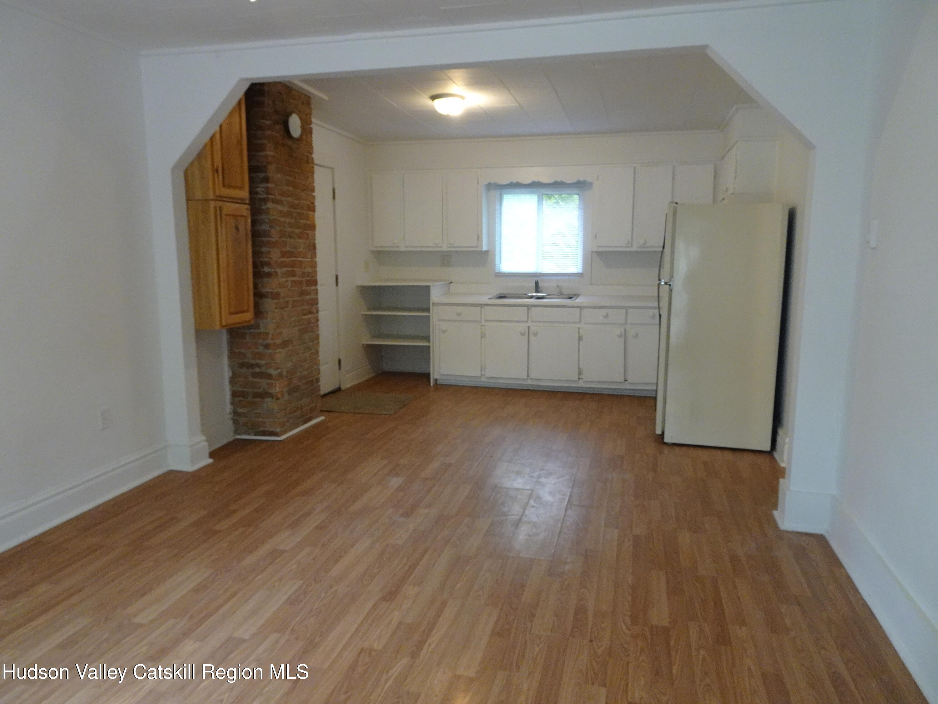 682 Highway 217 Hudson, NY 12534 - Photo 17 of 36 a view of an empty room with a window and wooden floor