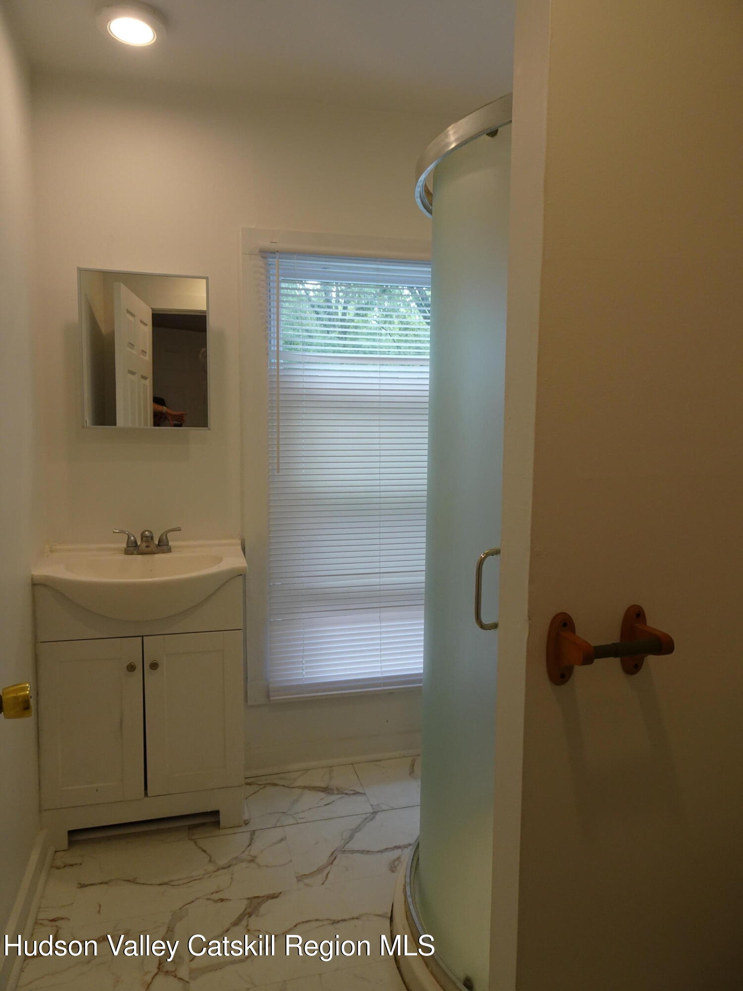 682 Highway 217 Hudson, NY 12534 - Photo 20 of 36 a bathroom with a sink a mirror and shower