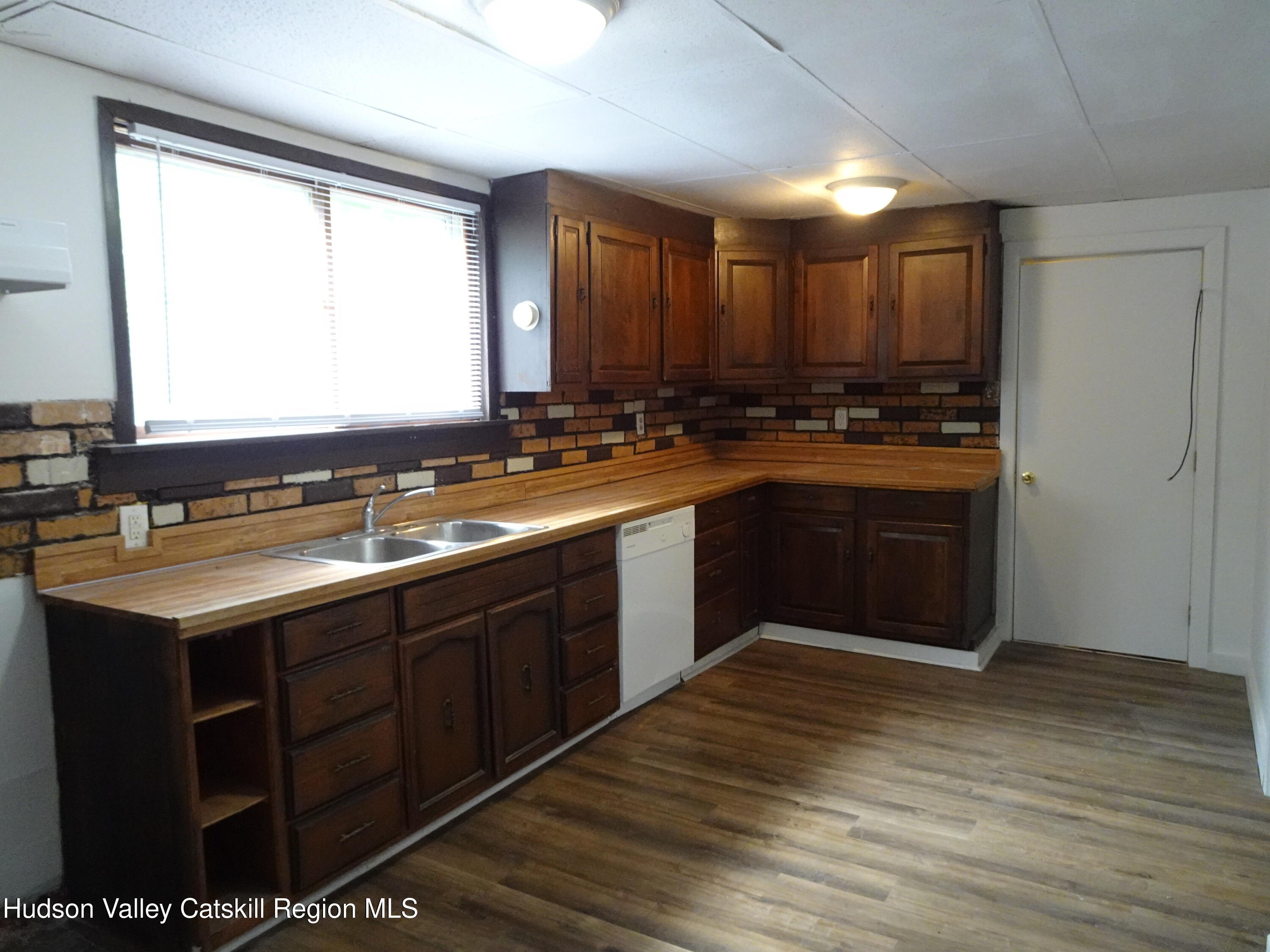 682 Highway 217 Hudson, NY 12534 - Photo 5 of 36 a large kitchen with a sink and cabinets