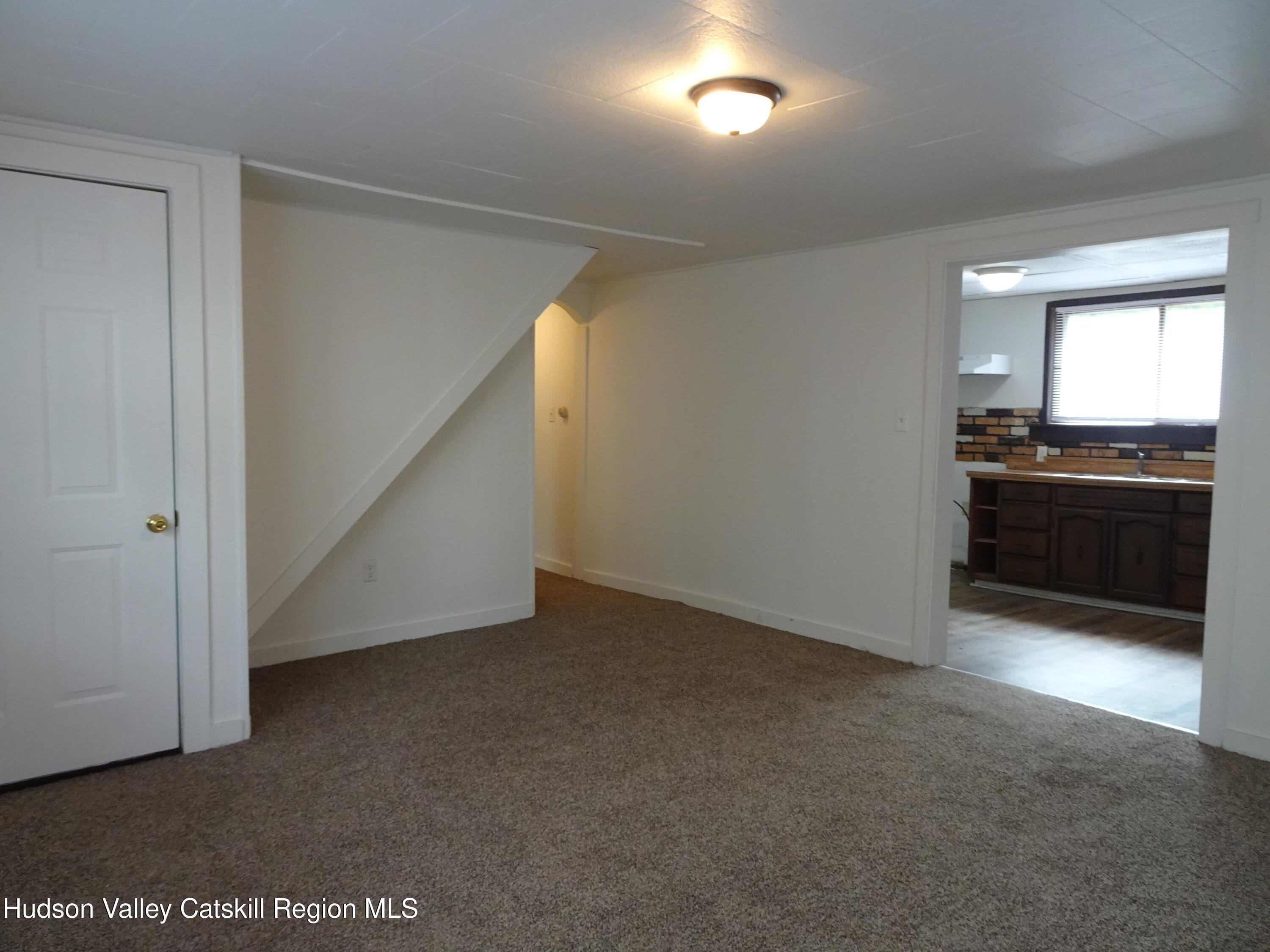 682 Highway 217 Hudson, NY 12534 - Photo 6 of 36 a view of an empty room with a kitchen
