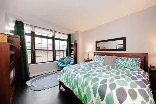 a bathroom with a toilet sink vanity granite and a shower