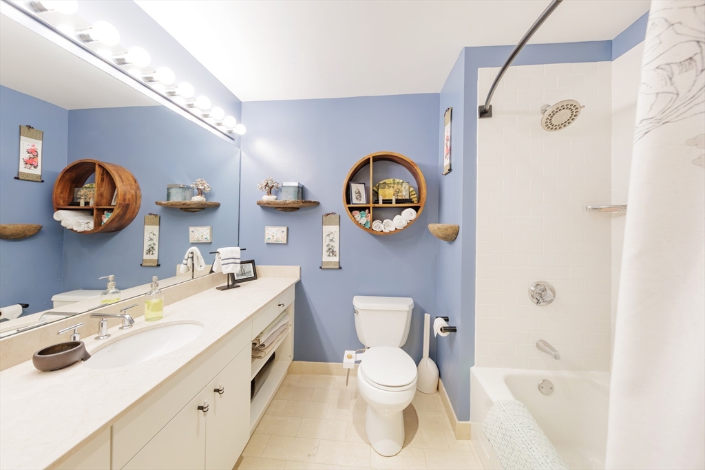 29 Otis Street, Unit 407 Cambridge, MA 02141 - Photo 12 of 31 a bathroom with a toilet sink vanity granite and a shower