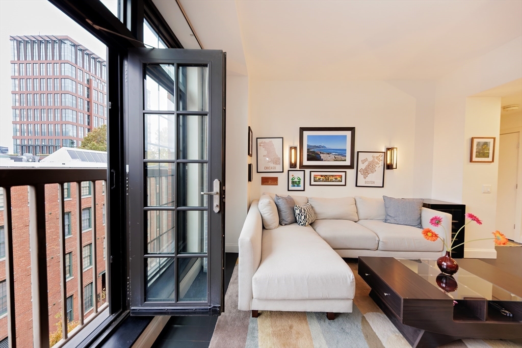 29 Otis Street, Unit 407 Cambridge, MA 02141 - Photo 4 of 31 a living room with furniture and a floor to ceiling window