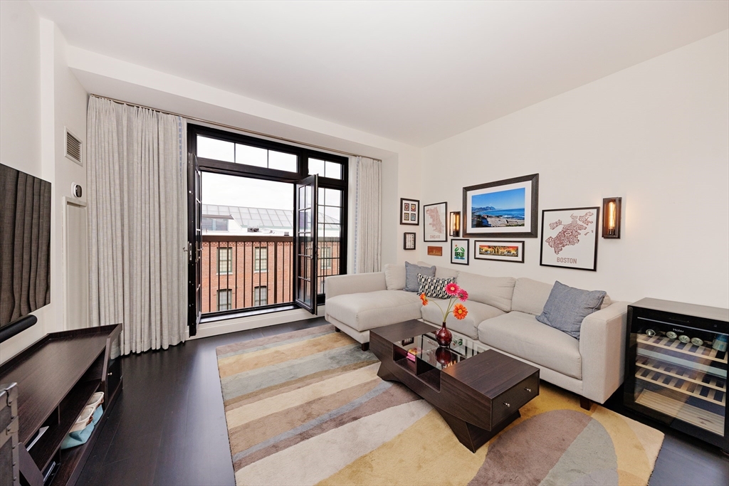 29 Otis Street, Unit 407 Cambridge, MA 02141 - Photo 5 of 31 a living room with furniture and a flat screen tv