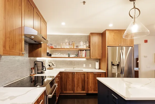 a kitchen with a sink appliances and cabinets