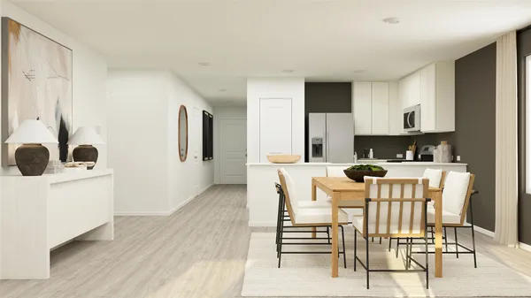 a kitchen with a dining table chairs and white cabinets