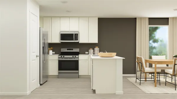 a kitchen with a stove a sink and a microwave