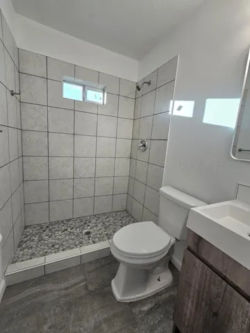 a bathroom with a toilet and a shower