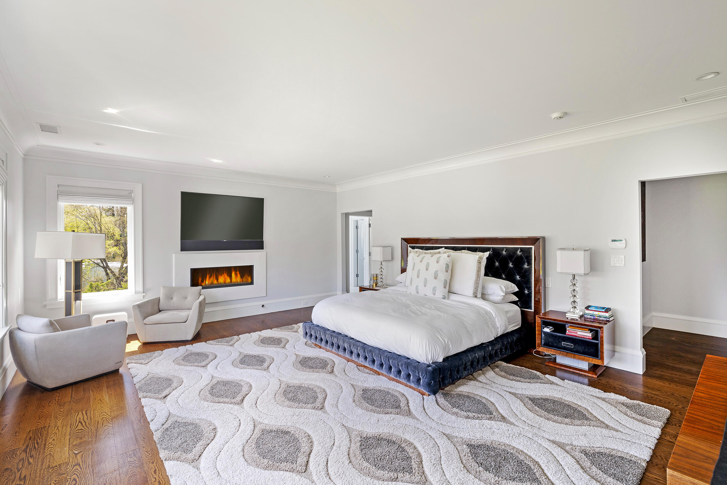 549 Oenoke Ridge New Canaan, CT 06840 - Photo 21 of 54 a bedroom with a bed and a flat screen tv