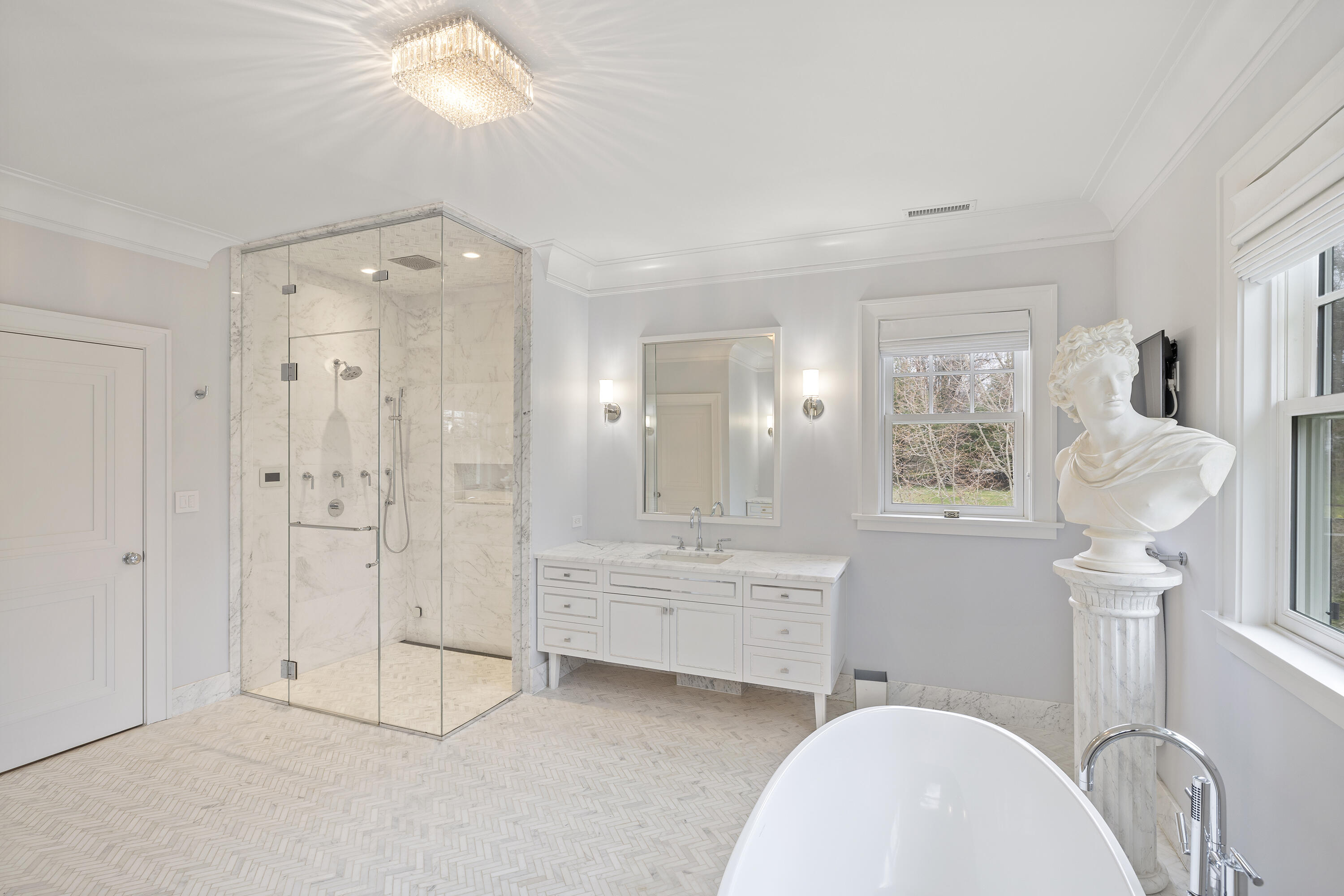 549 Oenoke Ridge New Canaan, CT 06840 - Photo 23 of 54 a spacious bathroom with a mirror a bathtub and shower