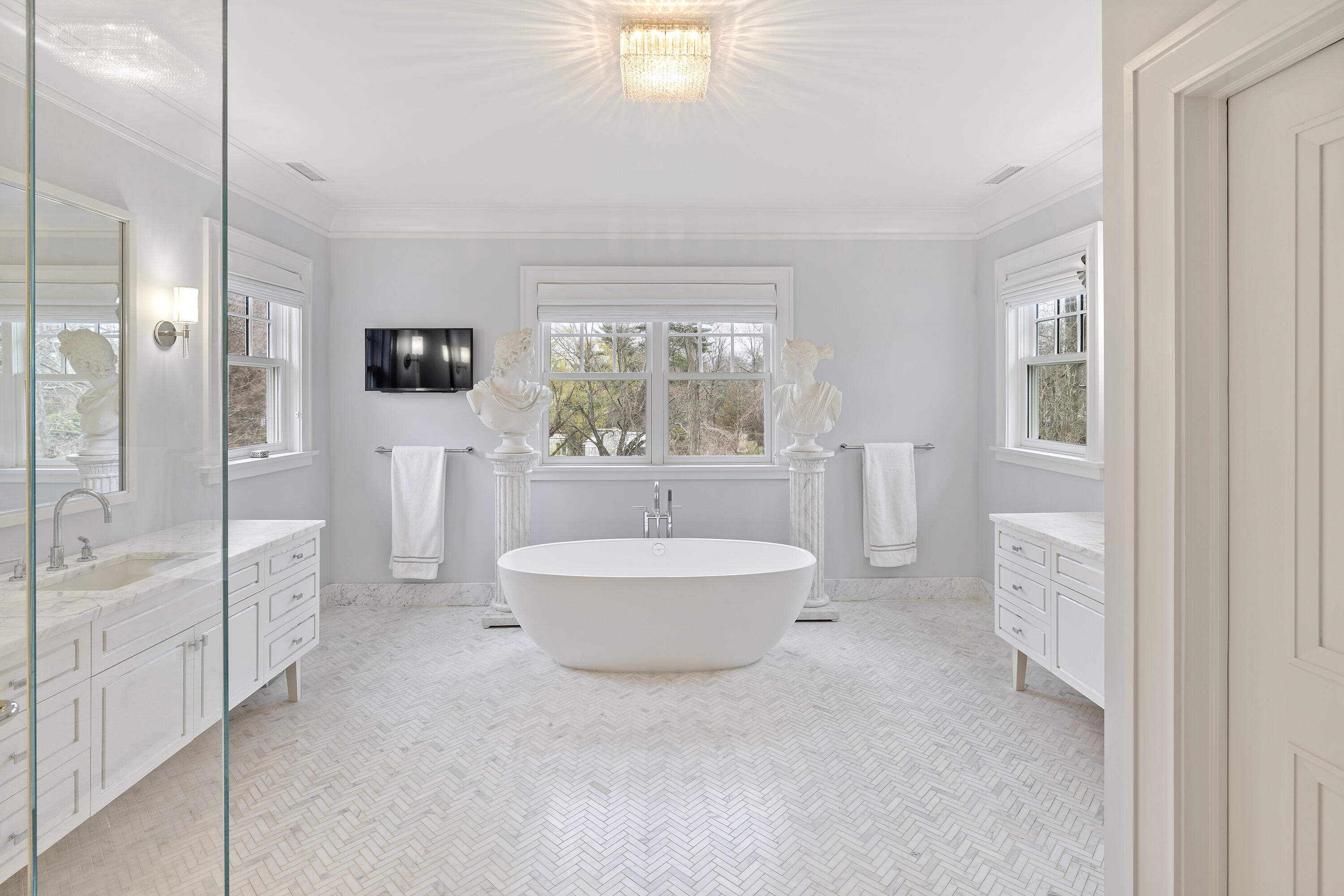 549 Oenoke Ridge New Canaan, CT 06840 - Photo 24 of 54 a spacious bathroom with a bathtub shower sink and a toilet
