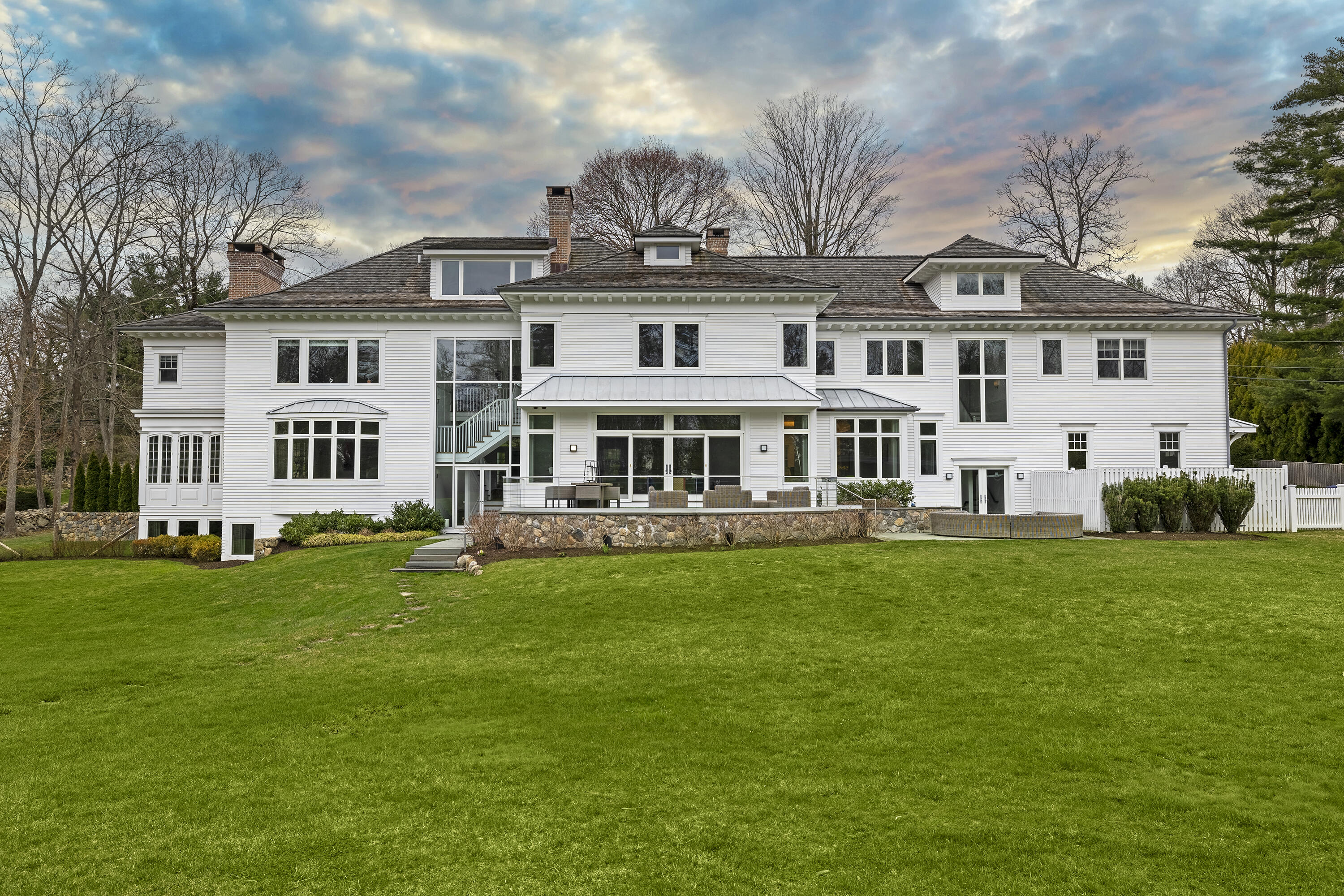 549 Oenoke Ridge New Canaan, CT 06840 - Photo 46 of 54 a front view of a house with a garden