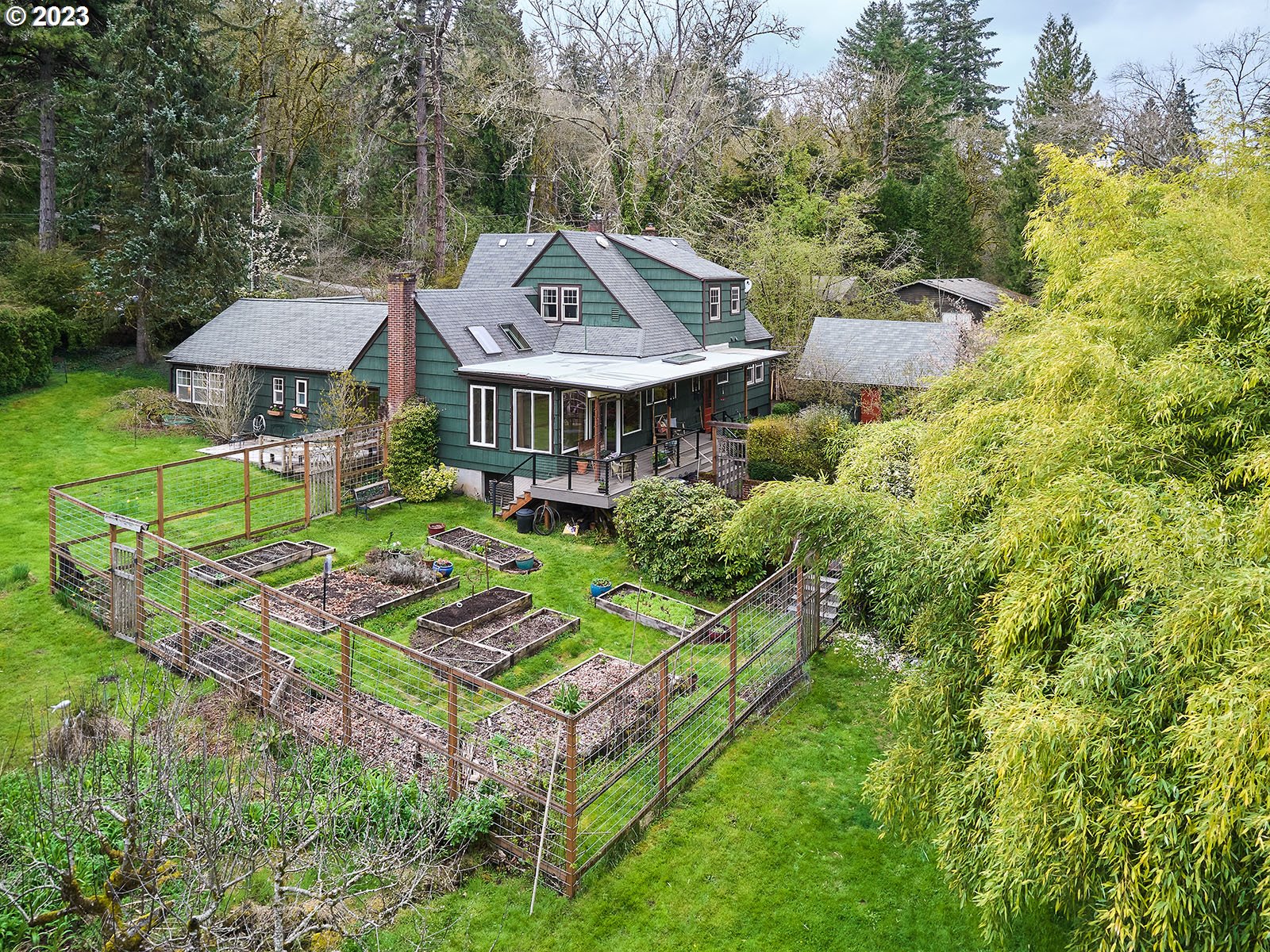 a aerial view of a house with yard and patio