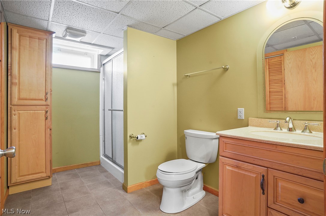 2633 Deibel Road Clinton, OH 44216 - Photo 26 of 40 Bathroom featuring tile patterned floors, a drop ceiling, toilet, and vanity