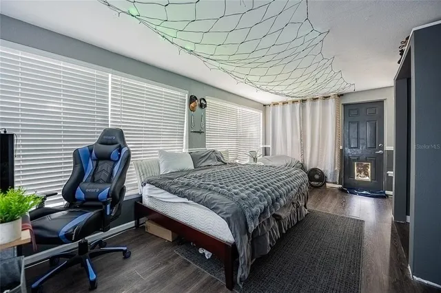 a bedroom with a bed chair and window