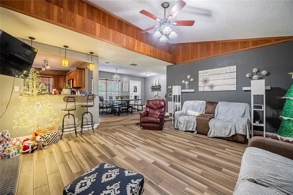 a living room with furniture and a chandelier