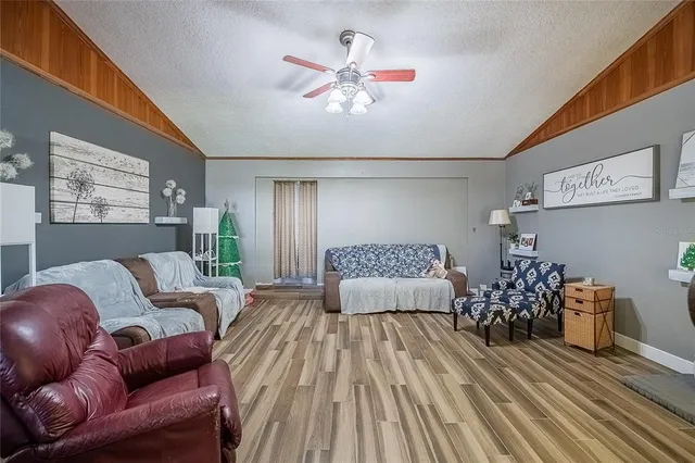 a living room with furniture and chandelier