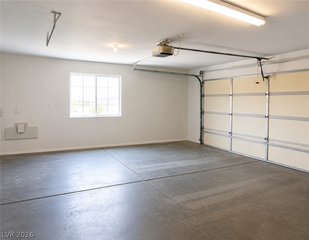 200 East Gamebird Road Pahrump, NV 89048 - Photo 19 of 23 Ample lighting illuminates this spacious garage with a functional window.