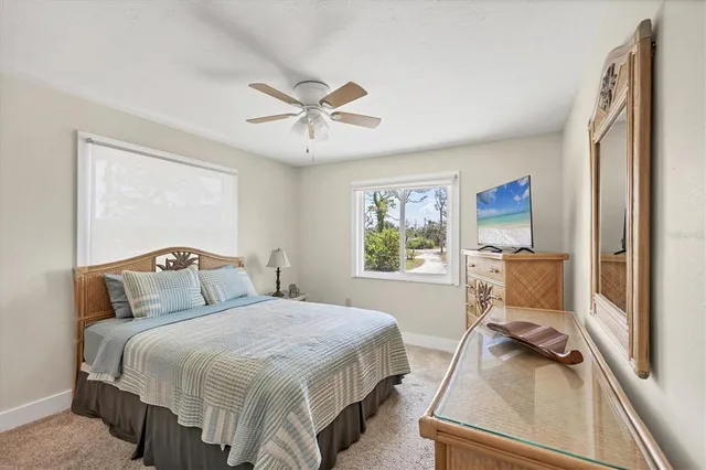 a spacious bedroom with a large bed and a chandelier
