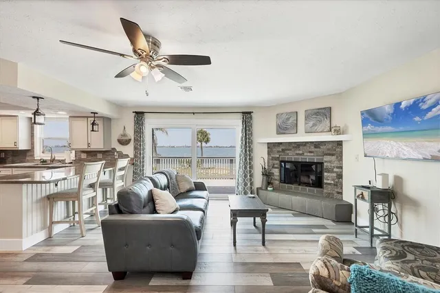a living room with fireplace furniture and a wooden floor
